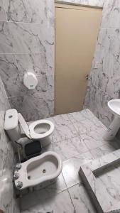 a bathroom with a toilet and a sink at Casa Celina in La Falda