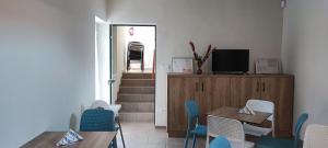 a dining room with a table and chairs and a staircase at Mazurek Balatonboglar in Balatonboglár