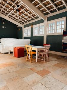 a room with a table and chairs and a bed at Condo-Resort Juquehy, 4 quartos, em frente ao mar in São Sebastião