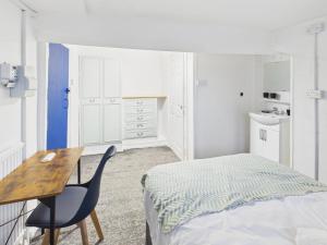 a bedroom with a bed and a desk and a chair at Parkview Guest House in King's Lynn