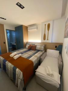 a hotel room with two beds and a bedskirts at Flat Caminho da Praia in Cabedelo +23 photos