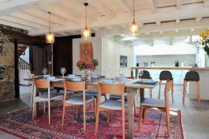 a dining room with a table and chairs on a rug at Casa Yañez in Chantada