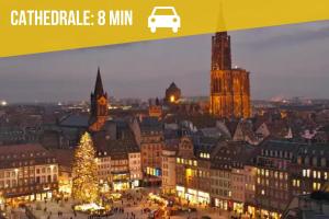 a city lit up at night with a christmas tree at Appartement Central avec Jacuzzi Privé I Strasbnb in Strasbourg