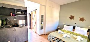 a kitchen and a bedroom with a bed and a sink at My Afytos Balcony in Afitos