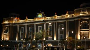 a building with a clock on top of it at night at Royal palm hotel and resort in Niāl