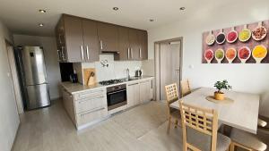 a kitchen with a table and a dining room at Apartmán Orchidea in Prešov