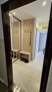 a bathroom with a mirror and a walk in closet at Apartmán Orchidea in Prešov +21 photos