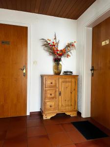 a vase on top of a wooden dresser in a room at Privathaus Sieglinde in Sondermoning