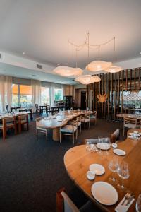 a dining room with tables and chairs and chandeliers at Chateau Montchenot in Maipú