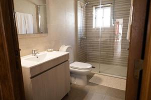 a bathroom with a toilet and a sink and a shower at Baleal Holiday House in Baleal +24 photos