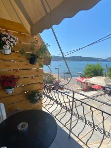 a balcony with a table and a view of the ocean at Eleni`s apartment Gialova, Giorgos House in Gialova
