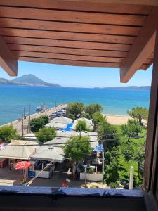 a view of the beach from a balcony of a resort at Eleni`s apartment Gialova, Giorgos House in Gialova +3 photos