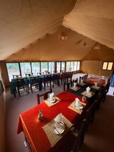 a dining room with tables and chairs in a tent at Elite Sahara Desert Camp in Merzouga