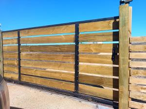 a wooden fence with a gate at Cabaña Litueche in Los Manantiales