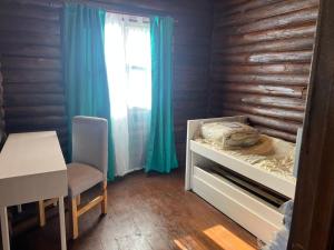 a bedroom with a bed and a table and a window at La Escondida in Estación Monte