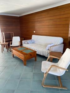 a living room with a couch and a table and chairs at High Level with Ocean Views Everywhere in Buddina