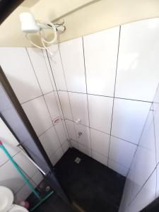 a bathroom with white tiles on the wall at Colman Apart Central in Ciudad del Este +12 photos