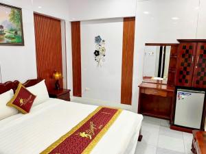 a hotel room with a bed and a dresser at Stargazer Hotel in Danang