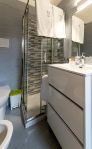 a bathroom with a shower and a sink and a toilet at Sto bene al mare in Termoli +27 photos