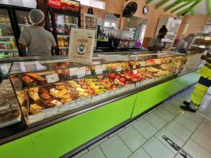 a bakery with a display case filled with different types of food at La Case Saint-Pierre in Saint-Pierre
