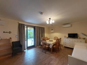 a kitchen and dining room with a table and chairs at Balaton Breeze Retreat in Balatonfüred