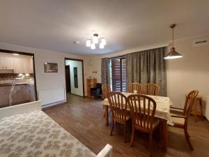 a dining room and kitchen with a table and chairs at Balaton Breeze Retreat in Balatonfüred