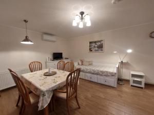 a dining room with a table and a bed at Balaton Breeze Retreat in Balatonfüred