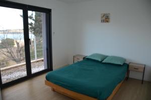 a bedroom with a bed and a large window at à la cime du mont Saint Clair in Sète +9 photos