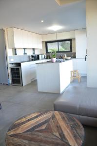 a kitchen and living room with a wooden table at à la cime du mont Saint Clair in Sète