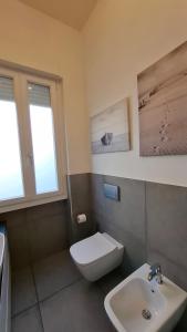 a bathroom with a white toilet and a sink at Casa Silvan in Sesto Fiorentino +16 photos
