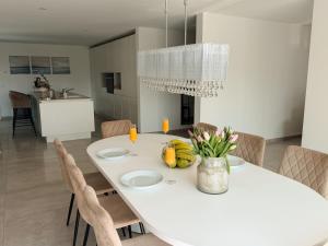 a white dining room with a white table and chairs at Luxury Apartments Marz in Schwanau