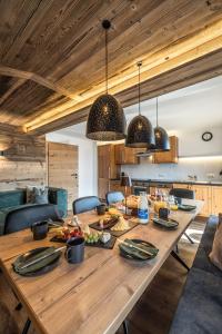 a large wooden table with food on it in a kitchen at Haus Barbara in Alpbach