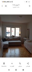a living room with a couch and two windows at Karlskrona centrum in Karlskrona