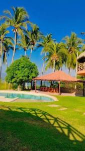 a resort with a swimming pool and palm trees at Laguinn Hotel Acapulco in Acapulco