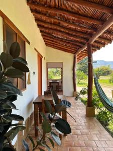 a patio with a table and a hammock at Trinitarios in Barichara