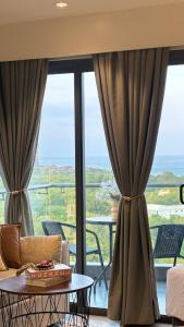 a living room with a couch and a table at 12th Floor Studio Tambuli, Sea View, Balcony in Maribago