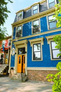 a blue house with a yellow door at Halifax's Most Popular Historic Modern Space in Halifax