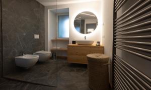 a bathroom with a sink and a toilet and a mirror at La casa del lupo in Colico +28 photos