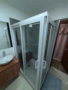 a bathroom with a glass shower and a sink at Hotel & Plaza San Blas in Comayagua