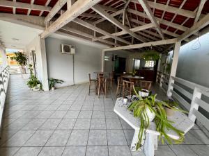a patio with tables and chairs in a building at Casa com churrasqueira e ar para até 8 pessoas in Guabiruba