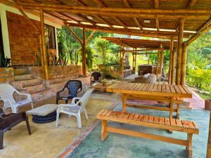 a patio with a table and chairs and a fireplace at Cabaña Campestre de Descanso in Melgar