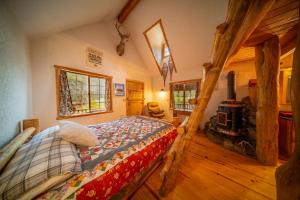 a bedroom with a bed and a fireplace in a cabin at Campfire Ranch All-Inclusive Lodge in Truckee