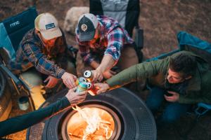 a group of people around a fire pit at Campfire Ranch All-Inclusive Lodge in Truckee