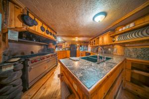 a kitchen with a sink and a stove at Campfire Ranch All-Inclusive Lodge in Truckee +17 photos
