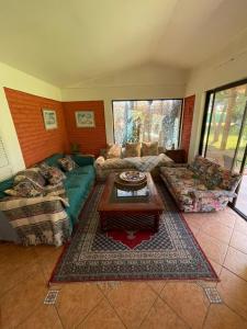 a living room with two couches and a coffee table at Casa Ordóñez - Cielo Abierto in El Molino