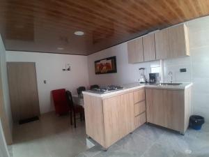 a kitchen with a sink and a counter top at Alojamiento y Confort in Tunja +12 photos