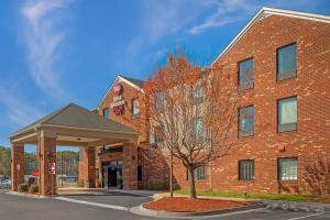 a brick building with a tree in front of it at Best Western Plus Glen Allen Inn in Richmond