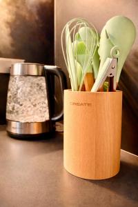 a container of kitchen utensils sitting on a counter at Miriam by Dozzze in Madrid