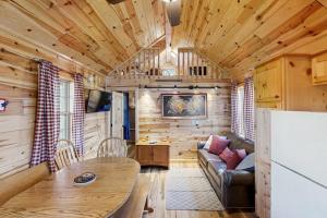 a living room with a couch and a table in a cabin at Meandering Moose Cabin in Florissant