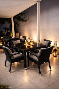 a black table and chairs with flowers on a patio at AR Vila Kikinda in Kikinda